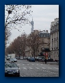 Paris Streets with a view of the top of the Eiffel Tower.