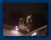 Notre Dame Cathedral as seen at night from the Seine river.